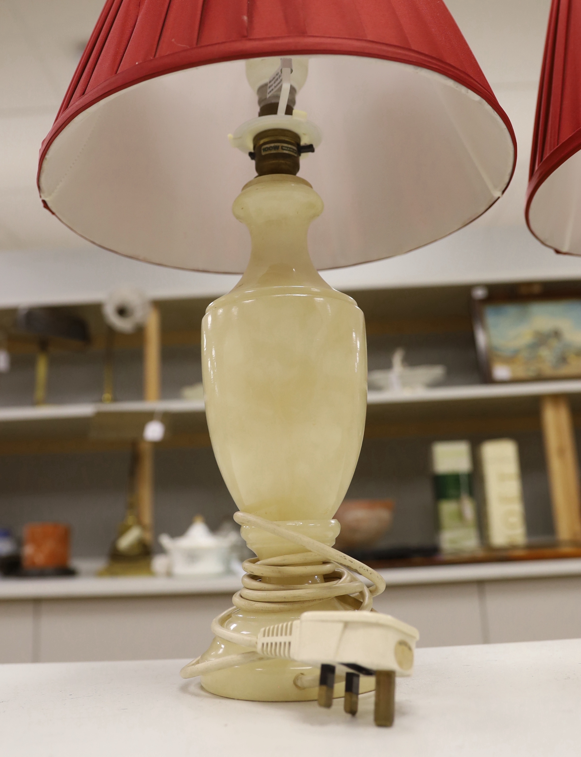 A pair of shaped alabaster table lamps, with shades, each 50cm high